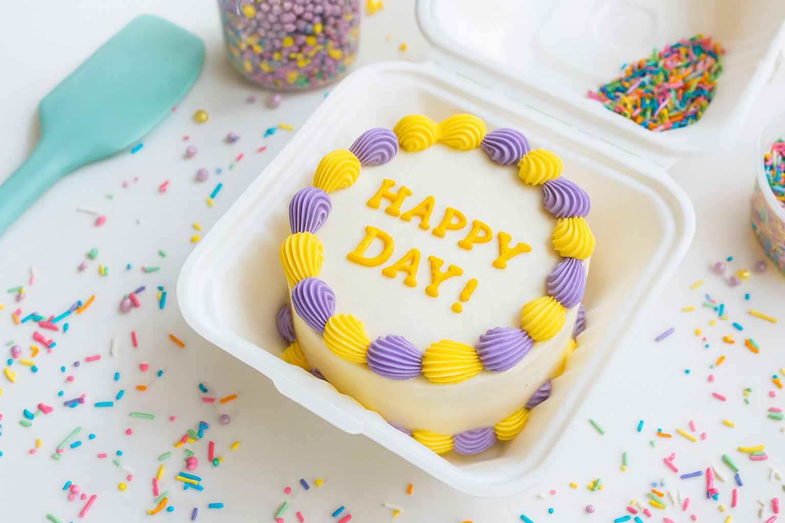 Bento box with a celebration cake and sprinkles